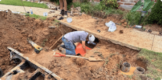 Plumber performing residential plumbing leak detection