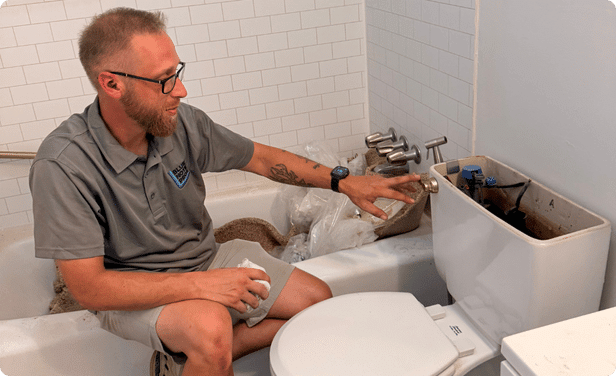 Plumber using equipment to inspect for a hidden water leak