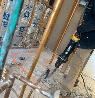 Blue Note Pros plumber breaking concrete for a remodel in Shreveport, LA.