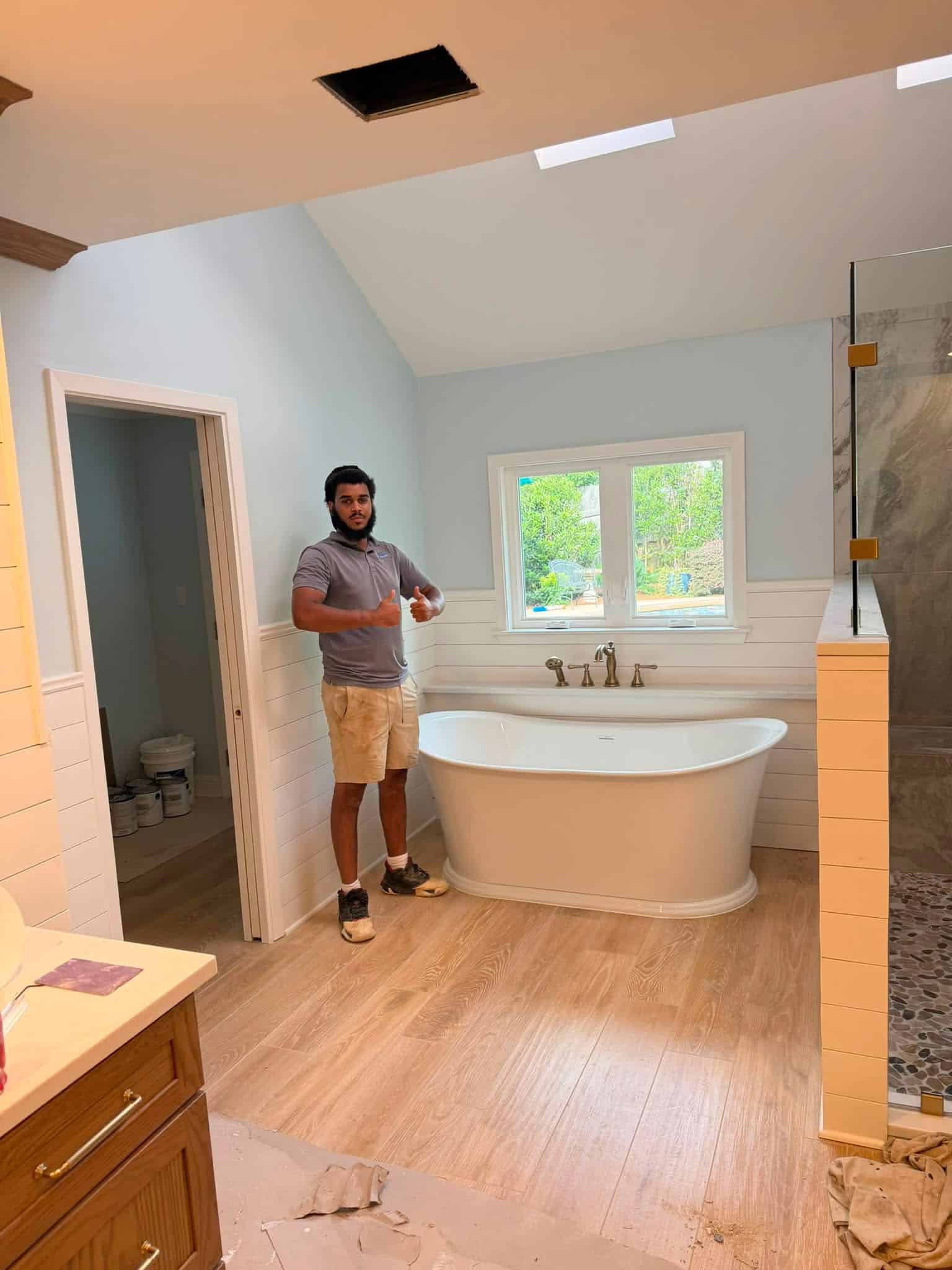Blue Note Pros bathroom remodel with a freestanding tub and new plumbing fixtures.