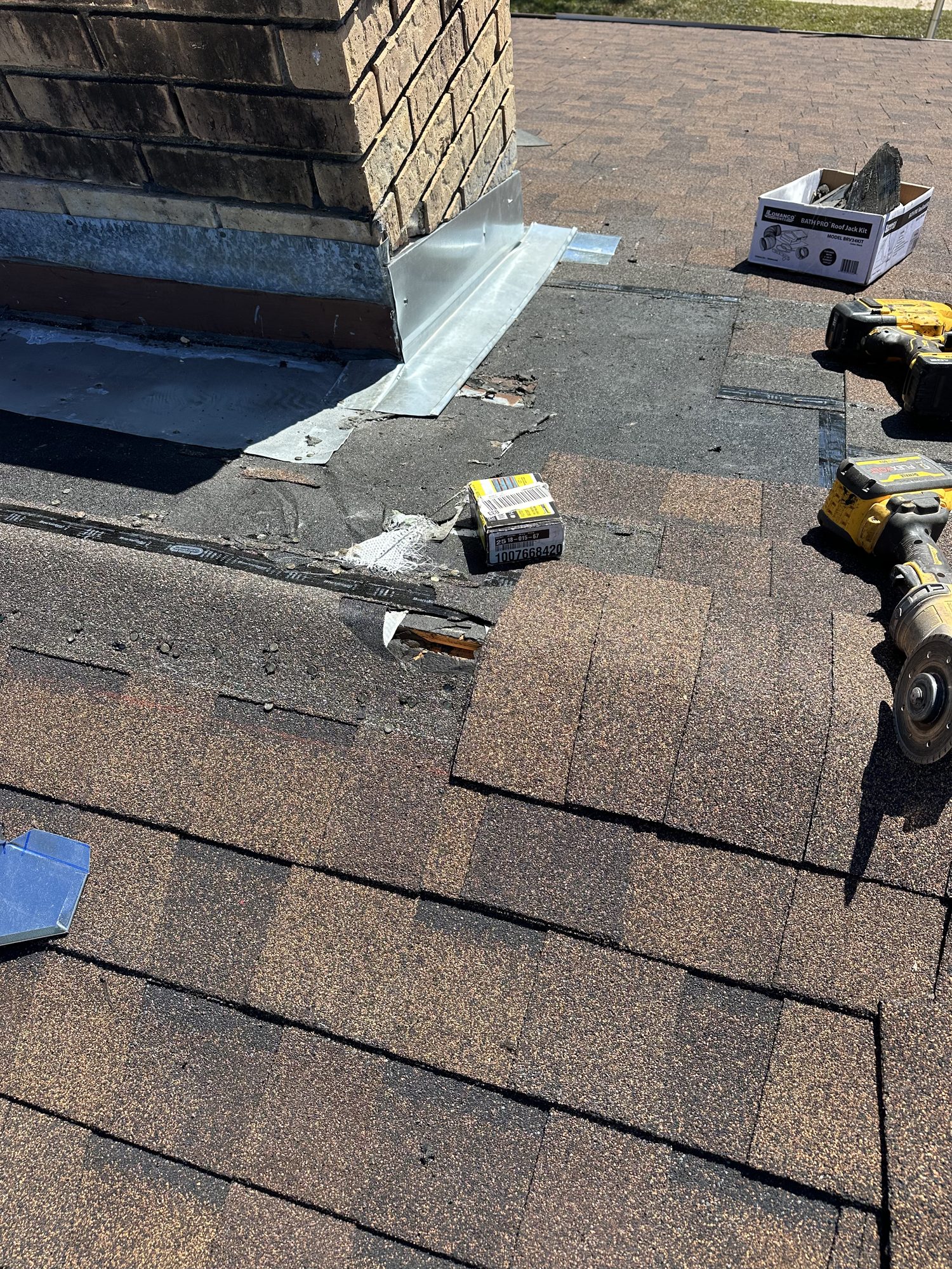 Blue Note Pros repairing chimney base flashing on a shingle roof