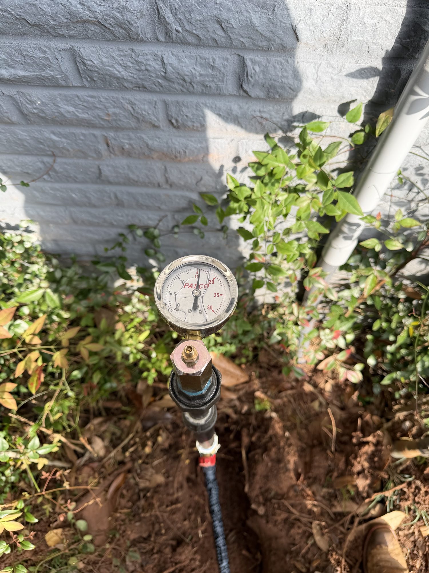 Pressure gauge on an outdoor spigot during a Blue Note Pros leak detection test