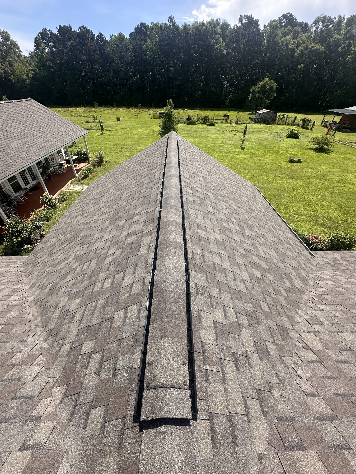 New shingle roof with ridge vent installed by Blue Note Pros