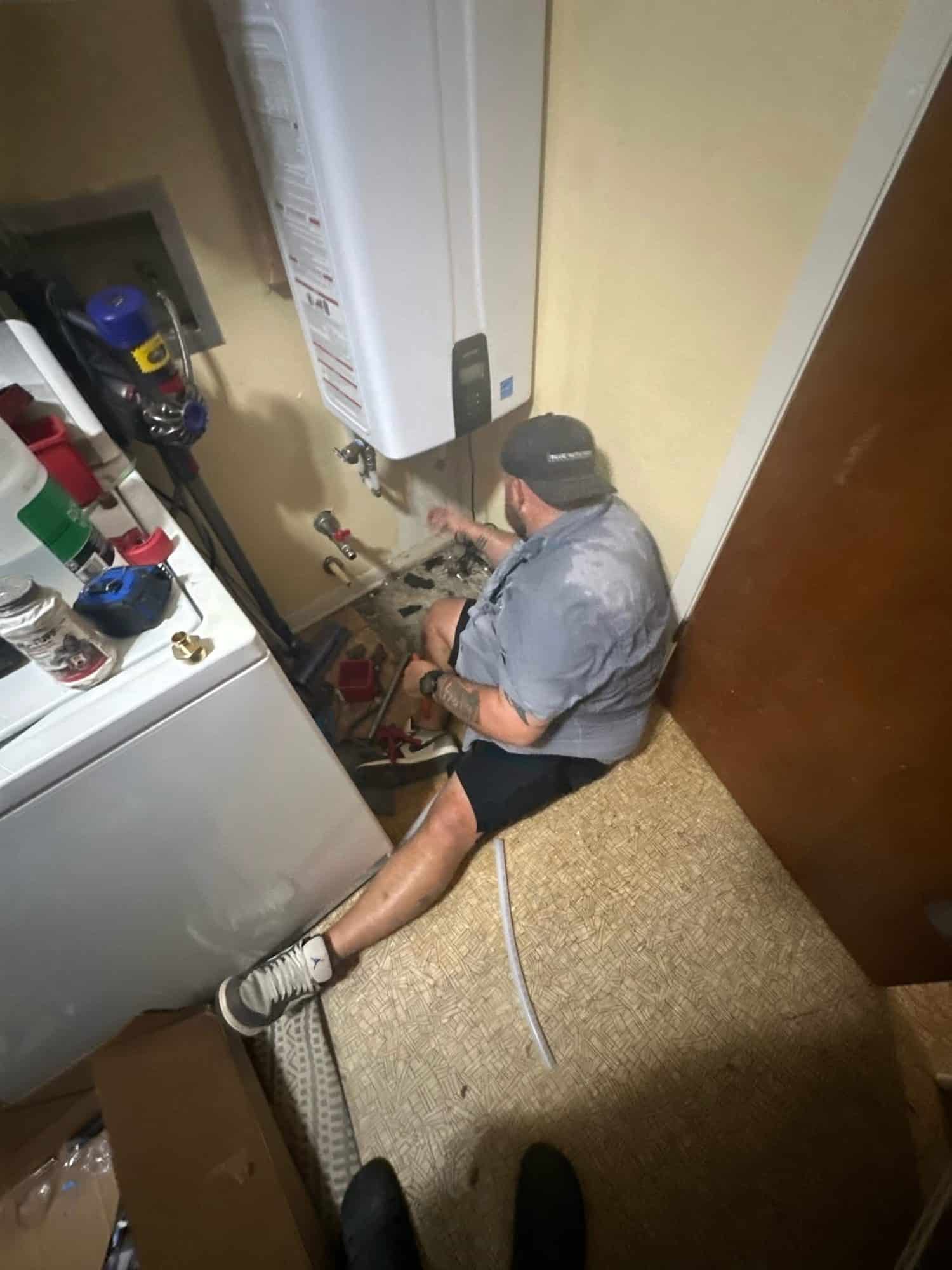 Alex Barajas of Blue Note Pros servicing a residential tankless water heater