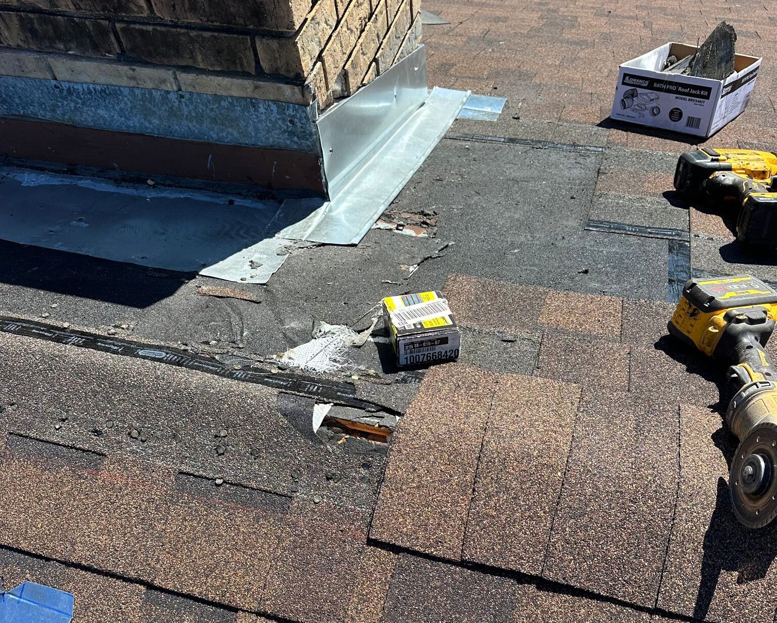 Roof repair in progress around a chimney in Shreveport, LA.